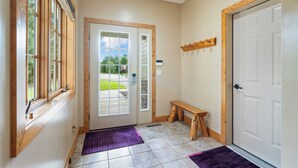 A hallway with a wooden bench, a door, and a window with blinds. - Kayaks, Indoor Pool, Hot Tub, Condo 841 (Crosslake)