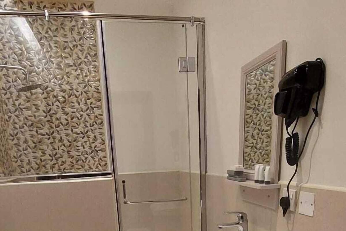 Separate tub and shower, slippers, towels, soap