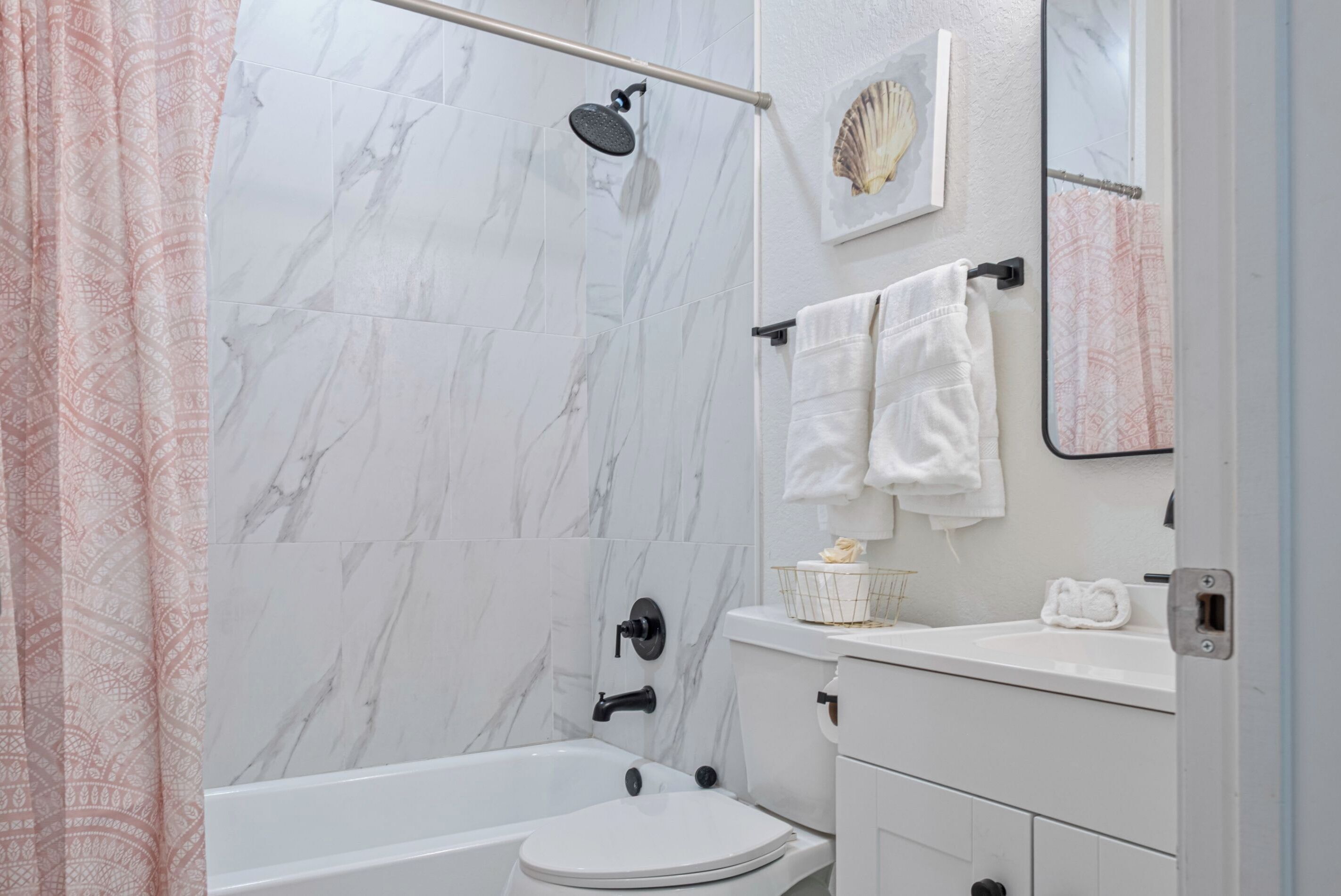 A bathroom with a bathtub, toilet, and a shower.