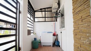 A narrow corridor with a window, a mop, a bucket, and a water dispenser. - 1 Bedroom Lumina Home Subdivision in Bacolod City (Bacolod)