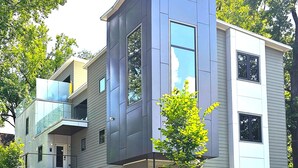 A modern two-story building with a flat roof, large windows, and a small tree in the front yard. - Cruisehaus ATL- handicap accessible, 4 beds on main floor (Atlanta)