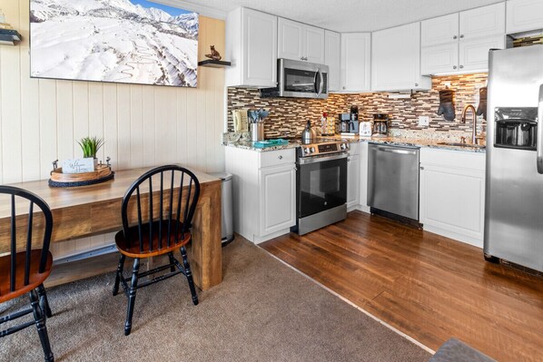 Fridge, stovetop, dishwasher, coffee/tea maker