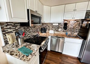 Fridge, stovetop, dishwasher, coffee/tea maker