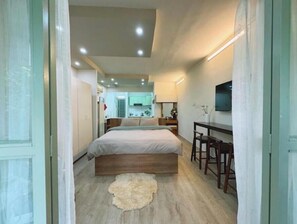 A bedroom with a bed, a desk, and a chair. - 57P3F-SweetHeart in SaiGon (Thành phố Hồ Chí Minh)