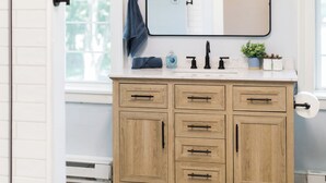 A bathroom with a wooden vanity, a large mirror, and pendant lights. - The River House-- Secluded, Serene, Hot tub & Firepit (Bellbrook)