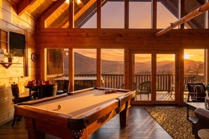 A pool table in a wooden room with large windows and a view of mountains. - Memorable Mountain Views w/ Hot Tub (Sevierville)