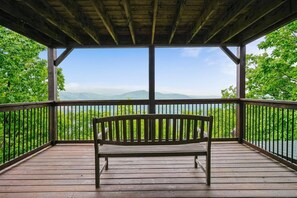 A wooden deck with a bench overlooking a body of water and distant mountains. - Sevierville - Halfway to Heaven #40 - 3 Bdrms. (Sevierville)