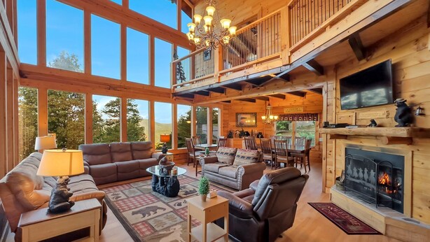 Un salón espacioso con chimenea, muebles de madera y ventanas amplias.