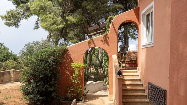 A stone staircase leading to a covered outdoor seating area with a view of trees and a clear sky. - Villa VILLACOLLE - Marsala (Marsala)