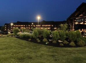 A lodge with multiple buildings, a well-maintained lawn, and a sign reading "GREAT W".