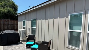 A patio with outdoor furniture, a barbecue grill, and a covered grill.