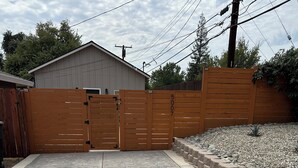 A gated driveway leading to a building with a garage.