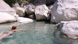 A person swimming in a natural pool surrounded by large rocks. - Chalet 2: Breakfast optional  (Aouste-sur-Sye)