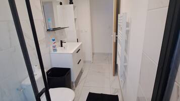 Shower, hair dryer, towels, toilet paper