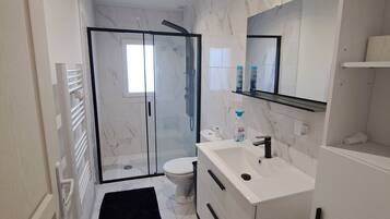 Shower, hair dryer, towels, toilet paper