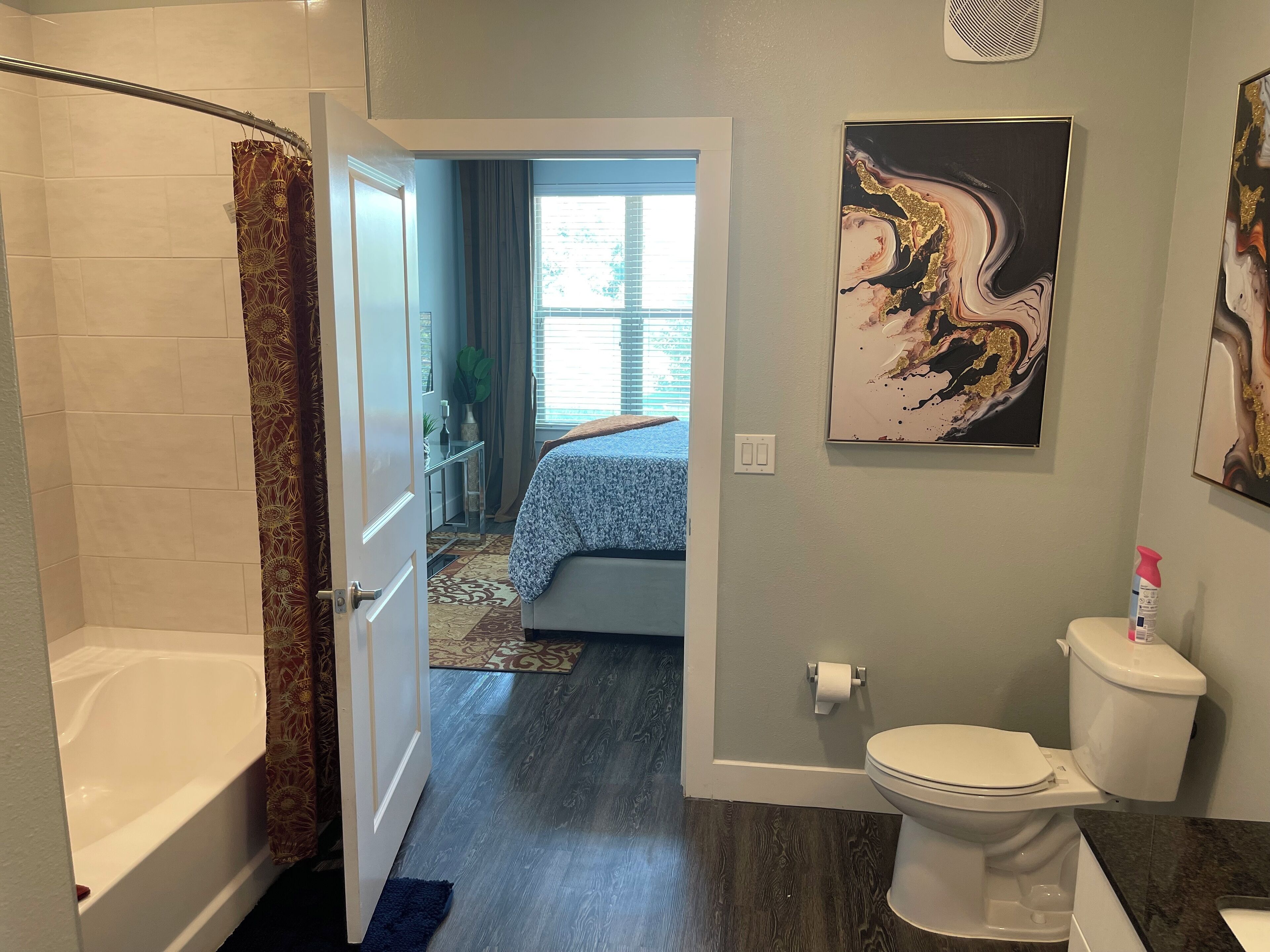 Une salle de bain avec une baignoire, des toilettes et un rideau de douche.