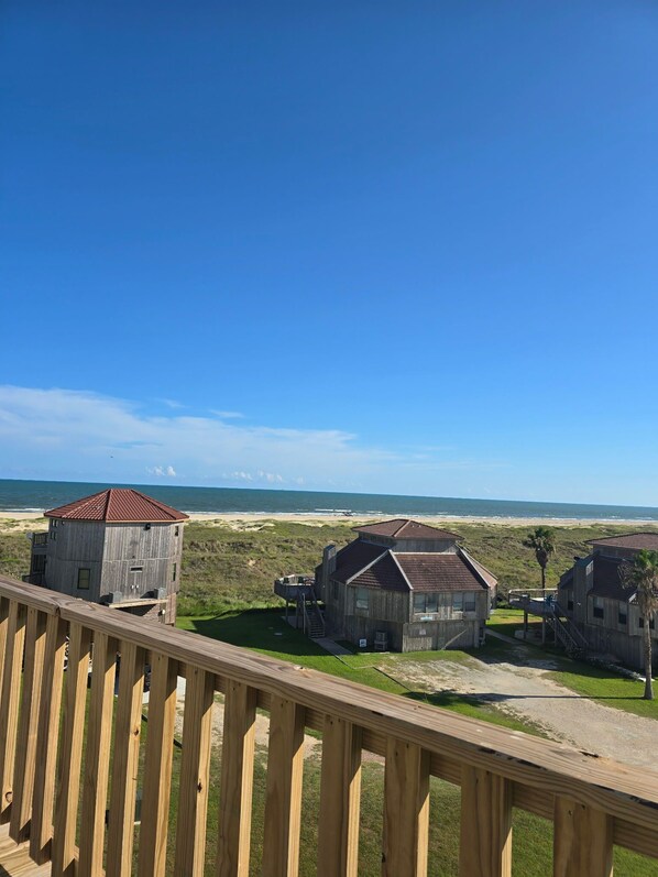 A wooden structure with a red roof overlooking a beach.