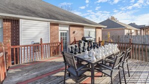 A wooden deck with a chessboard set up for a game.