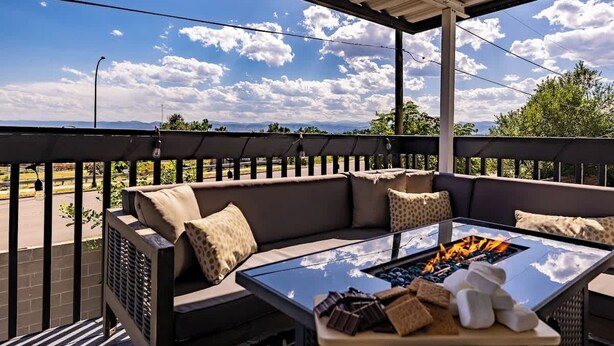 A covered outdoor seating area with a fire table, cushions, and snacks. - Hot Tub w Mountain View Pets OK (Westminster)