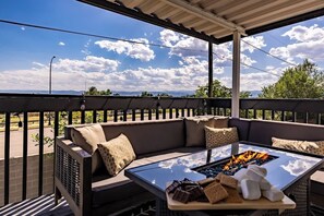 A covered outdoor seating area with a fire table, cushions, and snacks. - Hot Tub w Mountain View Pets OK (Westminster)