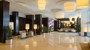 A modern lobby with a polished floor, dark-toned reception area, and contemporary lighting fixtures. - Ocean View Rental Surfers Paradise (Surfers Paradise)