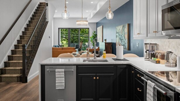 A modern kitchen with a central island, black cabinets, and a stainless steel oven. - PFR Suites - Butler|2-Story Lawrenceville Penthouse w/ Rooftop Terrace|2 King Beds /2.5 Bath|Parking (Pittsburgh)