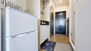 A compact kitchen with a refrigerator, a sink, and a door leading to another room. - 4min to Shinjuku, Close from Shibuya 1 ~ 2guests Tokyo CyberPunk Room (新宿区余丁町)