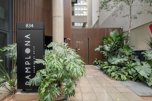 A modern building entrance with a sign reading "RAMPLONA" and the number "834". - STUDIO LYVVO 834 (São Paulo)