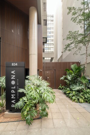 A modern building entrance with a sign reading "PAMPHONA STUDIO BY SETIN 834".