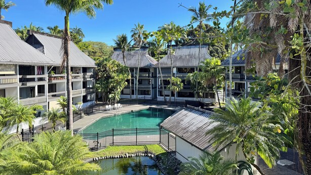 A resort with a central pool, multiple-story buildings, and lush tropical vegetation. - 5 Sunshine Rental ,A quiet and comfortable studio located HIlo Heart. (Hilo)