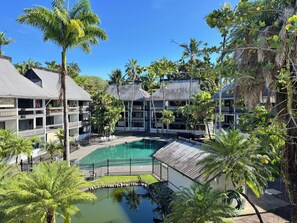 A resort with a central pool, multiple-story buildings, and lush tropical vegetation. - 5 Sunshine Rental ,A quiet and comfortable studio located HIlo Heart. (Hilo)