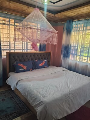 A bedroom with a bed, a canopy, and a view of the outdoors. -  3-bedroom house in Nyeri (Nyeri)