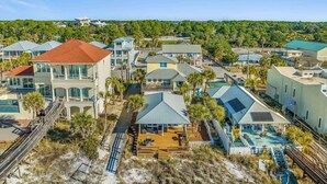 A coastal residential area with multiple houses, some with balconies and others with attached decks.