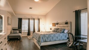 A bedroom with a bed, a desk, a chair, a dresser, and a window with blinds. - Spacious 4BDRM with a Stunning Pool+Game Room and Firepit (Bakersfield)