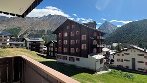 A building with multiple windows and balconies, surrounded by a mountainous landscape. - Haus Salü 5 by Interhome (Saas-Fee)
