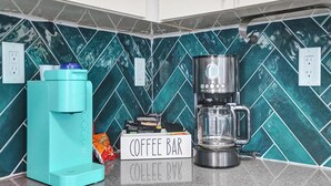A kitchen with a coffee bar setup, including a coffee maker and a water dispenser. - Palm Breeze Retreat . Close to Beach & Downtown (Hollywood)