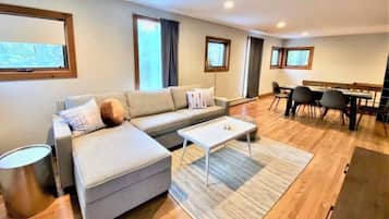 Signature House, 3 Bedrooms, Balcony, Lake View | Living room | 50-inch Smart TV with cable channels