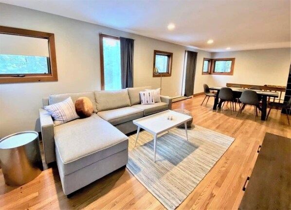 Signature House, 3 Bedrooms, Balcony, Lake View | Living room | 50-inch Smart TV with cable channels