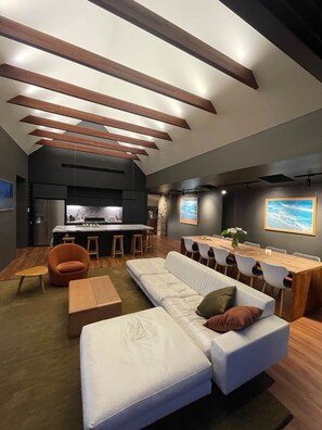 A modern interior with a kitchen, dining area, and seating.
