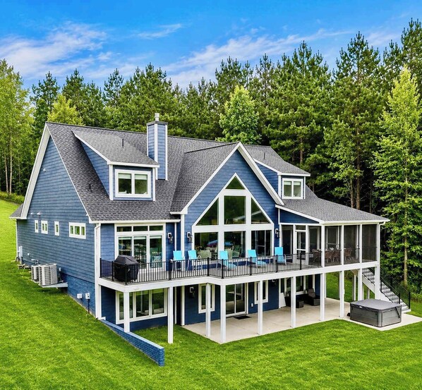A large house with a covered porch, multiple windows, and a chimney.