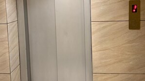 An elevator with a metallic interior and a digital display showing the number 3. - Hotel BTP INN (Nagpur)