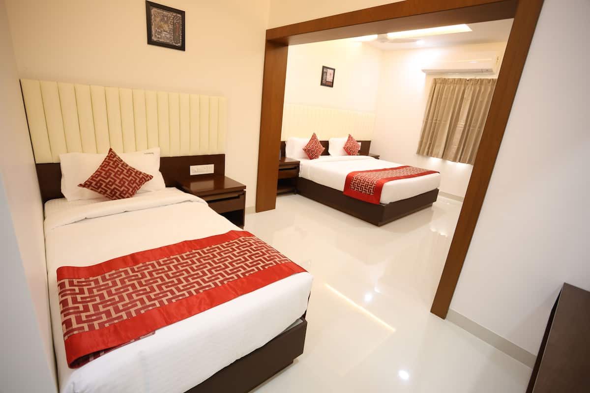 A hotel room with two beds, a large mirror, and a modern design.