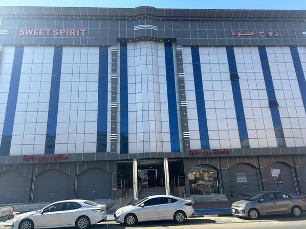 A building with a modern facade, featuring large windows and a sign that reads "SWEET SPIRIT".