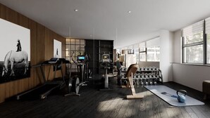 A modern gym with exercise equipment, a yoga mat, and a kettlebell. - chongqingyinshiguangjiangjingjiudian (Chongqing)