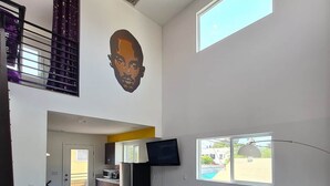 A modern living space with a dining area, kitchen, and a large window providing a view. - Kobe Bryant vacation getaway - 5 minutes to Rodeo Drive, Game console, Hot Tub (Beverly Hills)