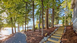 A pathway leading to a house with a view of a lake and trees. - The Belmont Lake Retreat -Sleeps 14! (Belmont)