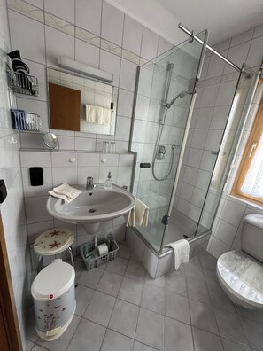 Shower, hair dryer, towels, toilet paper