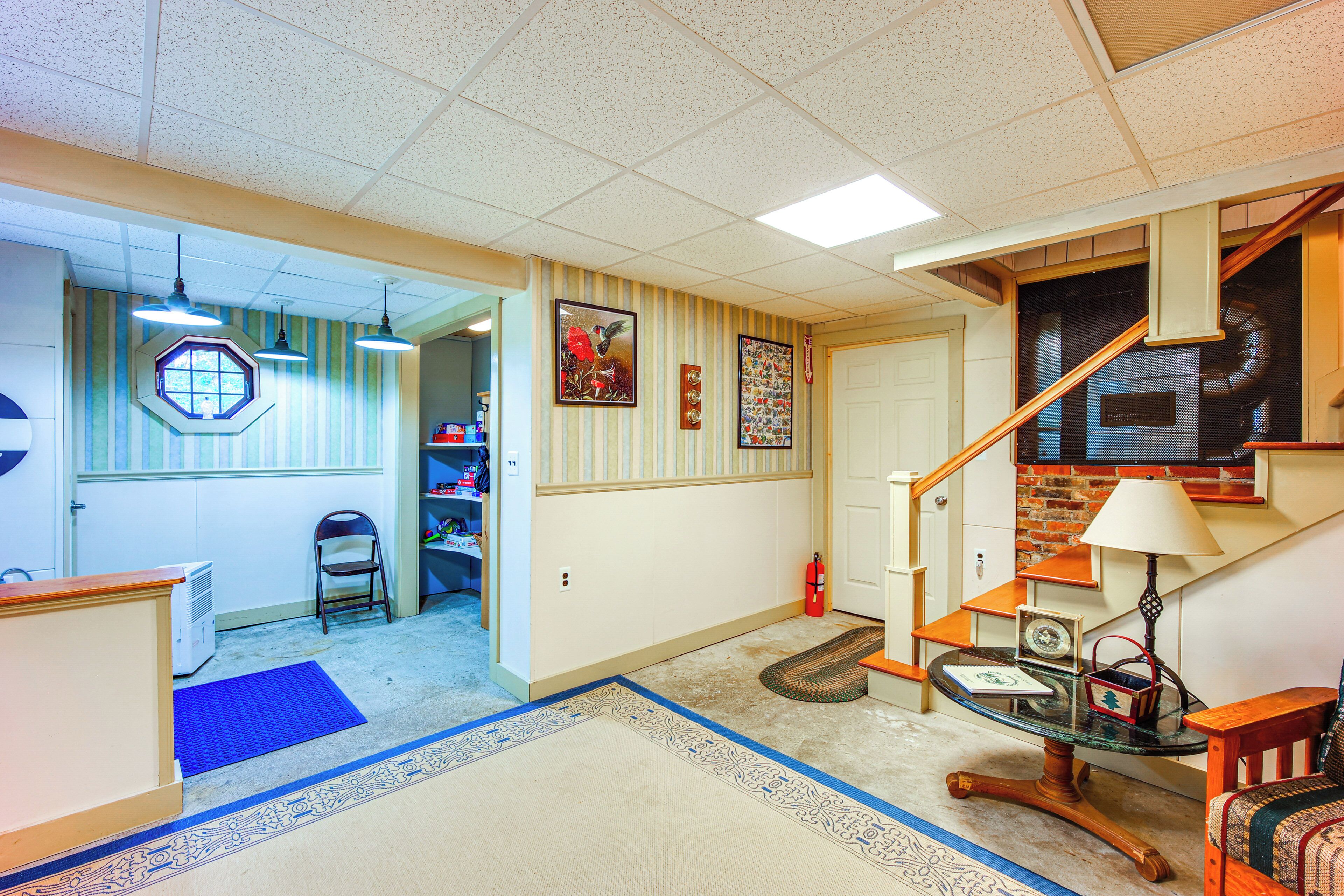 A spacious living room with a staircase, a dining area, and a kitchen.