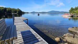 A wooden dock extending into calm water with a bench on the left. - Pine Camp*Seaplane/Boat Dock*Lake/Mountain View*Kayaks (Greenville)