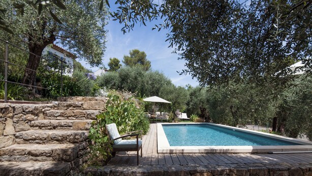 A stone staircase leading to a pool area with a chair and umbrella. - Separate room with pool access (Opio)